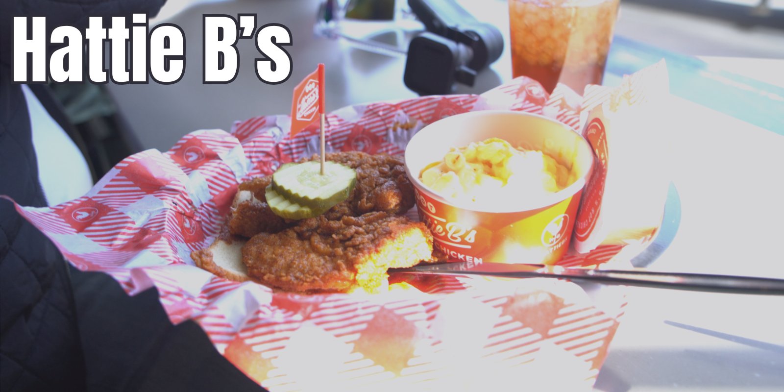 A tray of Hattie B's hot chicken with mac and cheese, pickles and a drink